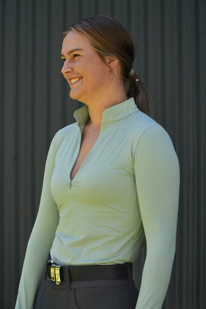 Model wearing lightweight perforated training shirt in Seafoam by Wilma Sport