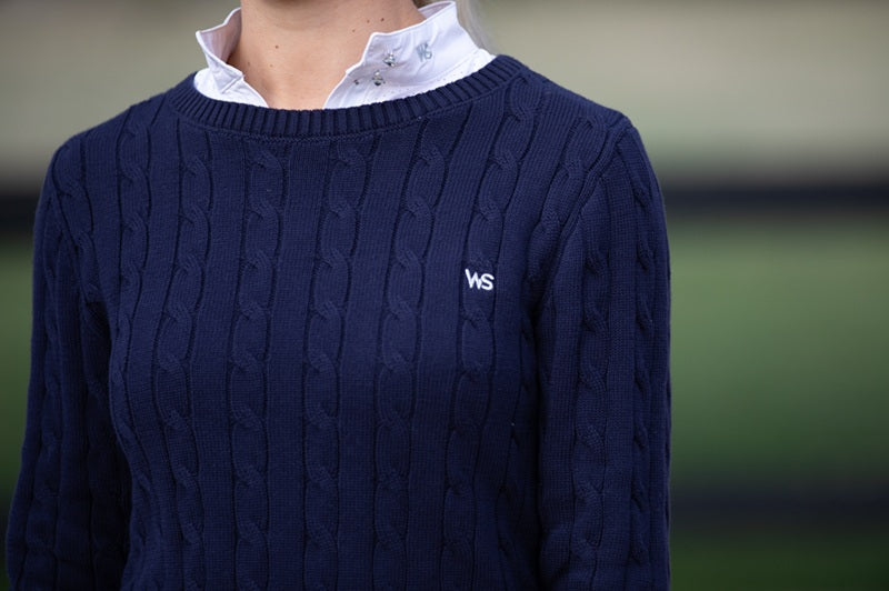 Close-up of Wilma Sport Signature Sweater in Midnight Navy showing WS embroidered logo and cable knit texture.