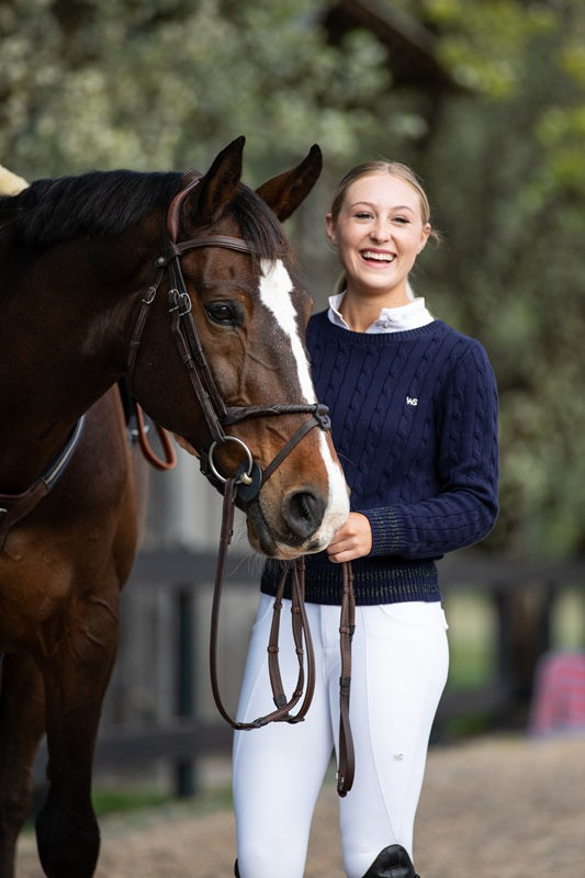 Model wearing Wilma Sport Signature Sweater in Midnight Navy with horse — elegant equestrian knitwear for competition or casual wear.